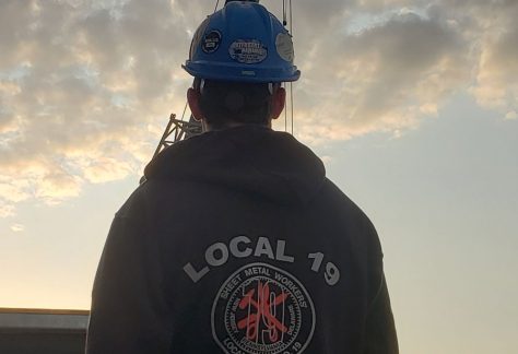 Sheet Metal Worker posing with Local 19 logo hoodie