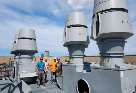 Sheet Metal Workers posing in a group jobsite photo on a roof