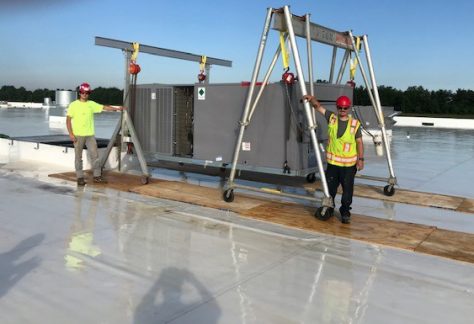 Sheet Metal Workers Apprentice Chris Knecht and Journeyman Vince Stringari working on a roof